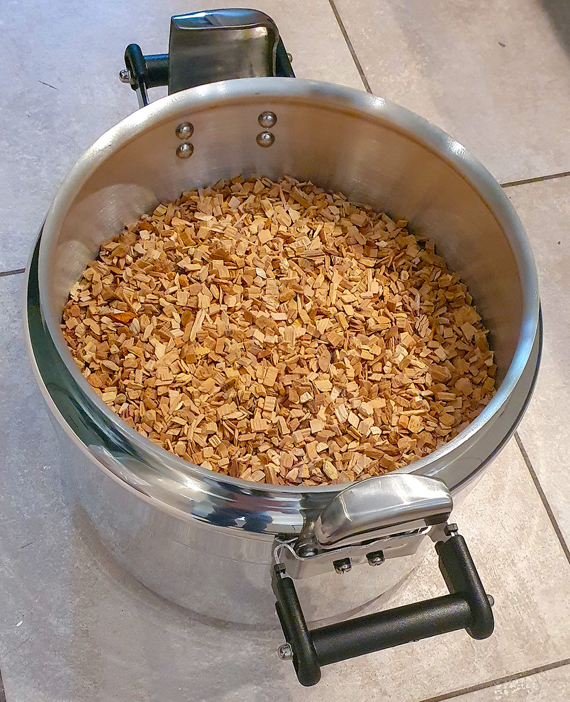 A pressure cooker with beechwood chips.